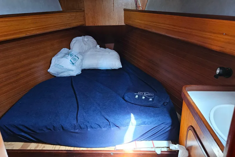 Slide: The Image of Cozy cabin interior of 1989 Gib'Sea 37 sailboat with bed and wooden paneling. - 33