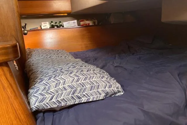 Slide: The Image of Cozy cabin interior of 1989 Gib'Sea 37 sailboat with patterned pillow and bedding. - 34