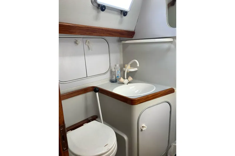 Slide: The Image of Compact bathroom in a 1989 Gib'Sea 37 sailboat, featuring sink and toilet. - 38