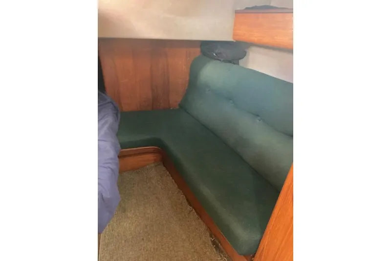 Slide: The Image of Interior of 1989 Gib'Sea 37 sailboat with green cushioned seating. - 39