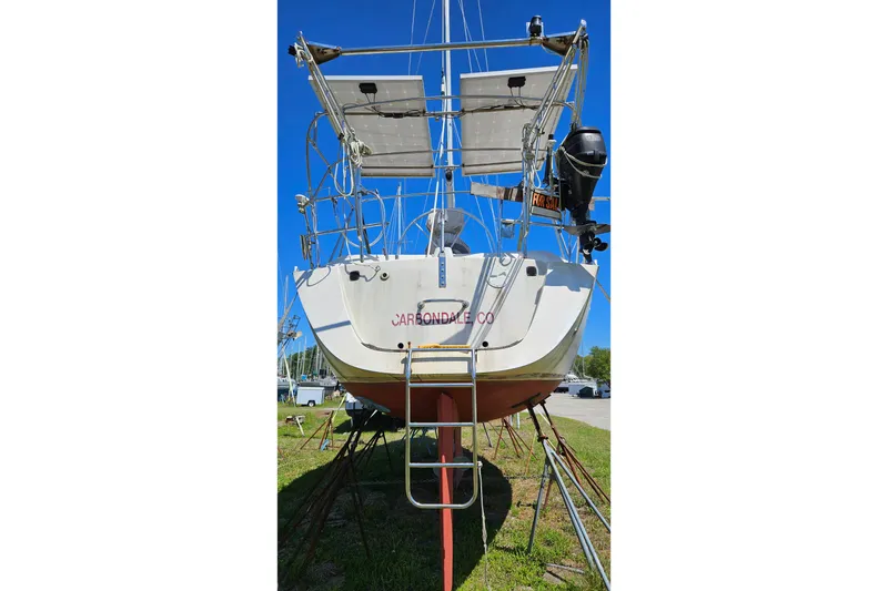 Slide: The Image of 1989 Gib'Sea 37 sailboat on land, equipped with solar panels and outboard motor. - 4