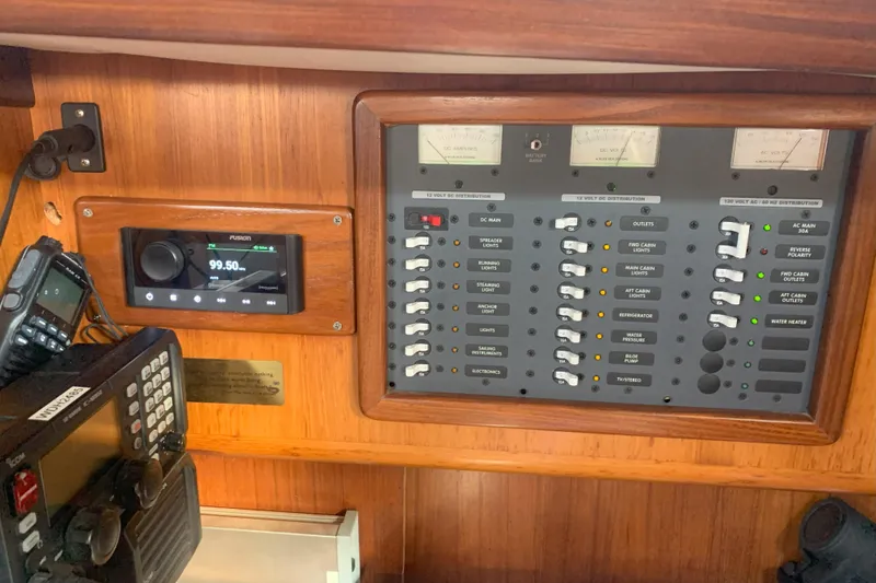 Slide: The Image of Electrical control panel on a 1989 Gib'Sea 37 sailboat, featuring radio and navigation equipment. - 40