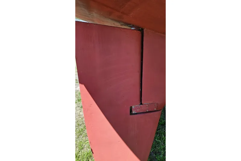 Slide: The Image of Red keel of 1989 Gib'Sea 37 sailboat on grass. - 44