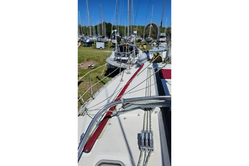 Slide: The Image of Sailboat deck view of 1989 Gib'Sea 37 in a marina with other boats. - 7