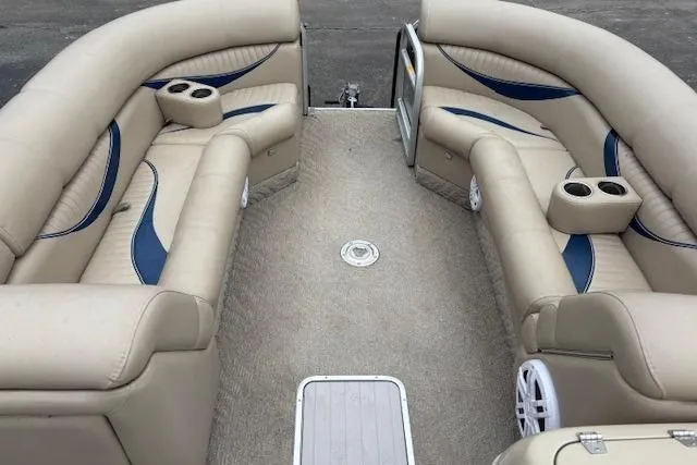 Slide: The Image of Interior of a 2011 Berkshire 243 SLX boat with beige seating and blue accents. - 10