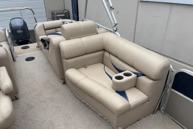 Slide: The Image of 2011 Berkshire 243 SLX pontoon boat with beige seating and cup holders. - 11