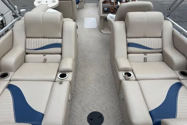 Slide: The Image of Interior of a 2011 Berkshire 243 SLX boat with beige and blue seating. - 5