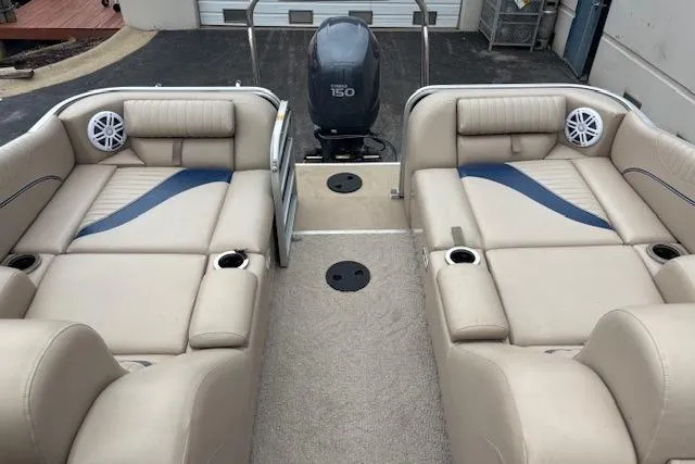 Slide: The Image of 2011 Berkshire 243 SLX boat interior with beige seating and Yamaha 150 engine. - 6