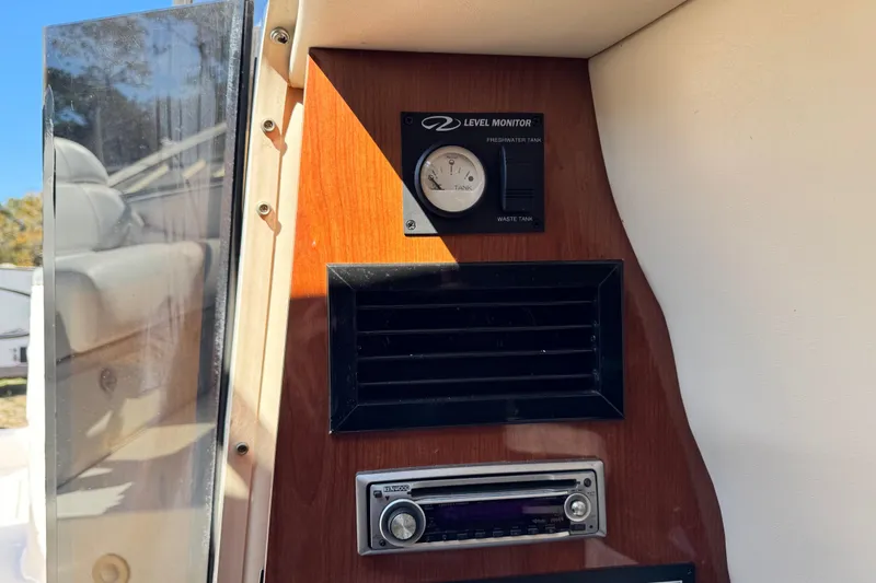 Slide: The Image of 2007 Regal Commodore 2665 dashboard with level monitor and stereo system. - 13