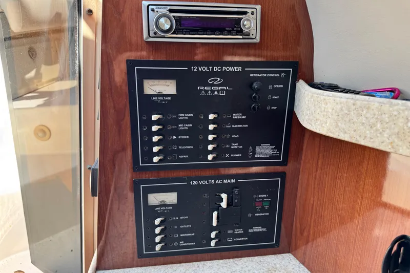 Slide: The Image of Control panel of a 2007 Regal Commodore 2665 boat with power switches and stereo. - 14