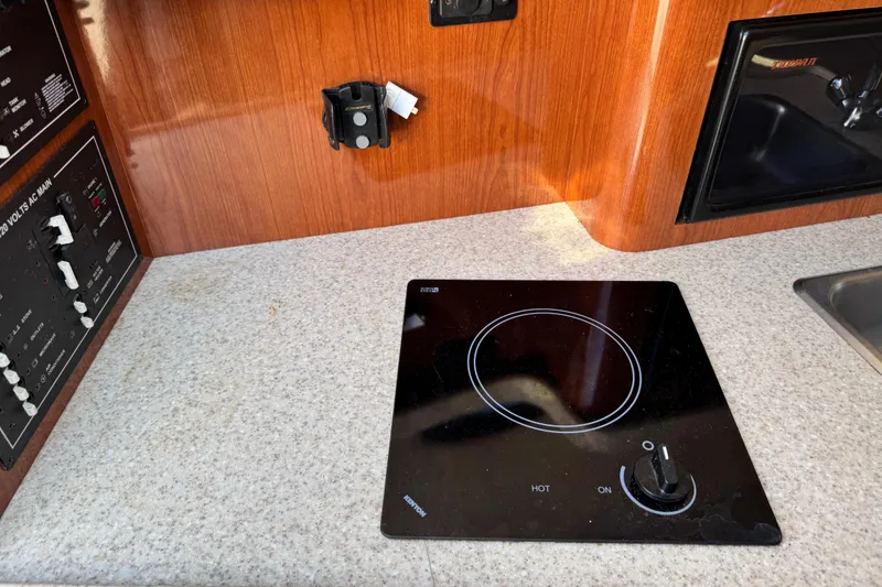 Slide: The Image of 2007 Regal Commodore 2665 boat interior with stove and control panel. - 15