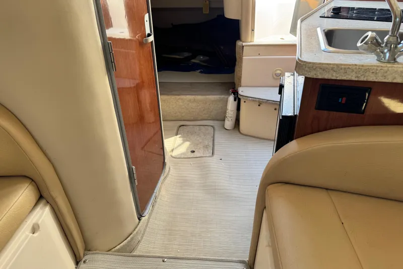 Slide: The Image of Interior of 2007 Regal Commodore 2665 boat, featuring cabin entrance and kitchenette area. - 18