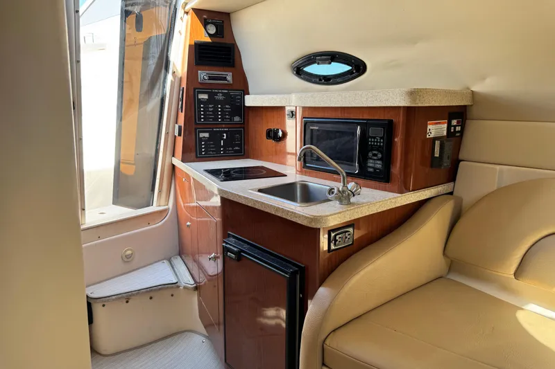 Slide: The Image of Interior of 2007 Regal Commodore 2665 boat with kitchenette and seating area. - 20