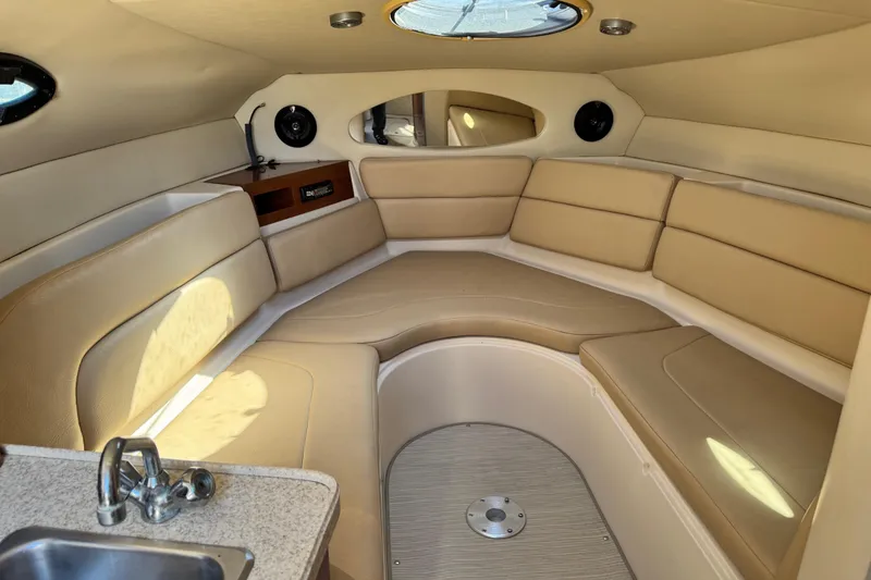 Slide: The Image of Luxurious interior of 2007 Regal Commodore 2665 boat with beige seating and kitchenette. - 21