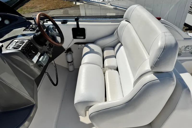 Slide: The Image of 2007 Regal Commodore 2665 boat interior with white seating and steering console. - 23