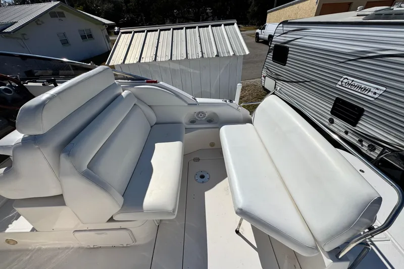 Slide: The Image of 2007 Regal Commodore 2665 boat interior with white seating and outdoor setting. - 25