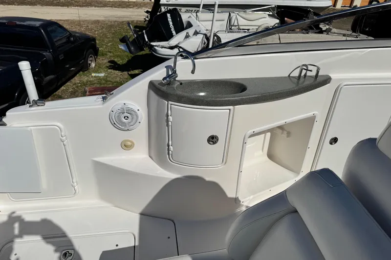 Slide: The Image of 2007 Regal Commodore 2665 boat interior with sink and storage compartments. - 26
