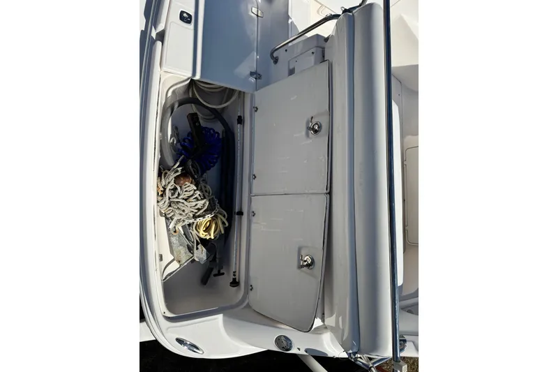 Slide: The Image of Storage compartment of 2007 Regal Commodore 2665 boat with ropes and equipment. - 29