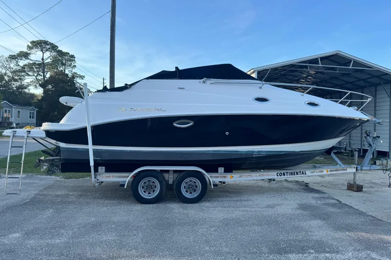 Slide: The Image of 2007 Regal Commodore 2665 boat on trailer, parked outdoors under clear sky. - 3