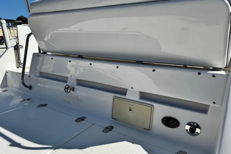 Slide: The Image of 2007 Regal Commodore 2665 boat interior, featuring white seating and control panel. - 31