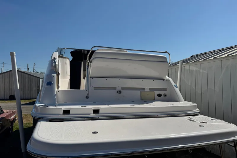 Slide: The Image of 2007 Regal Commodore 2665 boat stern view, docked under clear blue sky. - 33