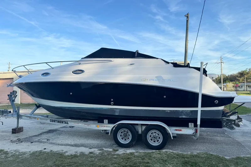 Slide: The Image of 2007 Regal Commodore 2665 boat on trailer, parked outdoors under clear sky. - 6