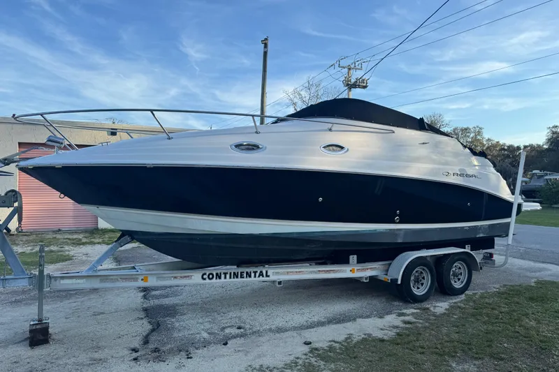 Slide: The Image of 2007 Regal Commodore 2665 boat on trailer, parked outdoors under clear sky. - 7
