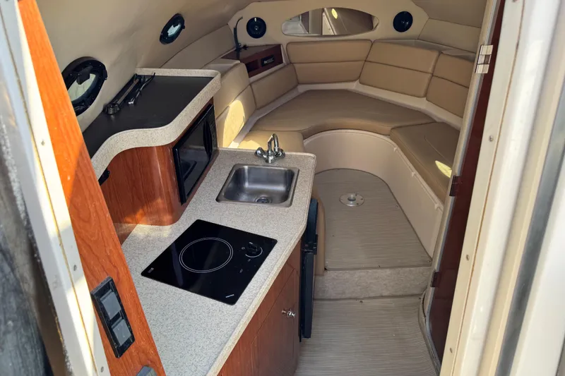 Slide: The Image of Interior of 2007 Regal Commodore 2665 boat with kitchenette and seating area. - 8