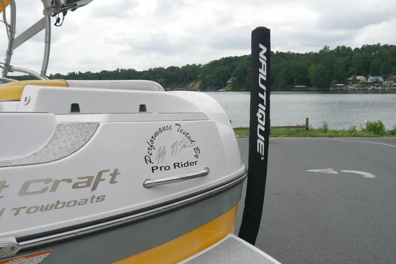 Slide: The Image of 2007 Correct Craft 236 Team Edition boat by a lake, featuring "Pro Rider" decal. - 32