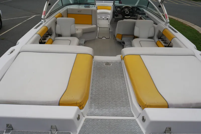 Slide: The Image of 2007 Correct Craft 236 Team Edition boat interior with yellow and white seating. - 36
