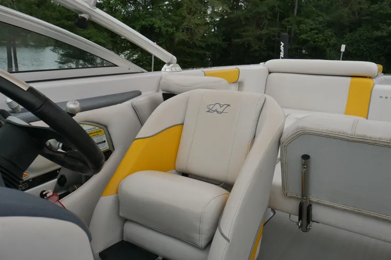Slide: The Image of 2007 Correct Craft 236 Team Edition boat interior with yellow and white seating. - 8