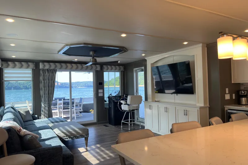Slide: The Image of Luxurious Sumerset Luxe II 2026 houseboat interior with lake view, modern furnishings, and large TV. - 10