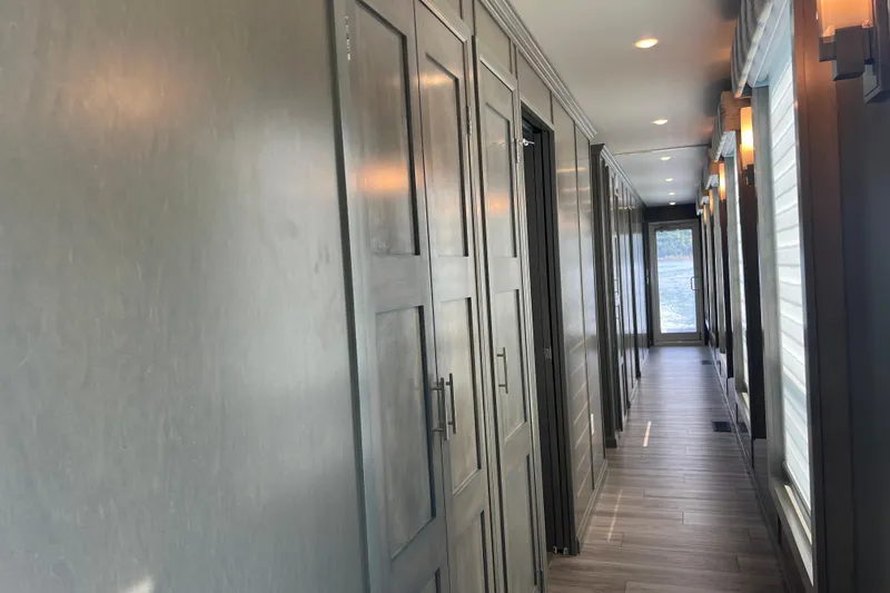 Slide: The Image of Modern hallway in 2026 Sumerset Luxe II houseboat with sleek wood paneling and ambient lighting. - 12