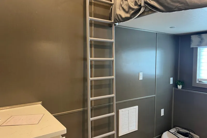 Slide: The Image of Interior of 2026 Sumerset Luxe II with ladder, loft bed, and modern decor. - 16