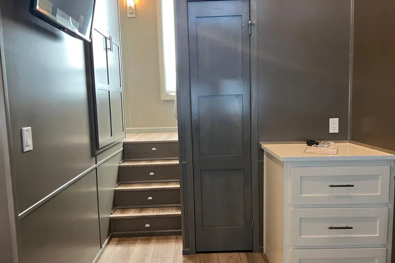 Slide: The Image of Interior of 2026 Sumerset Luxe II with modern cabinetry and stairs. - 17