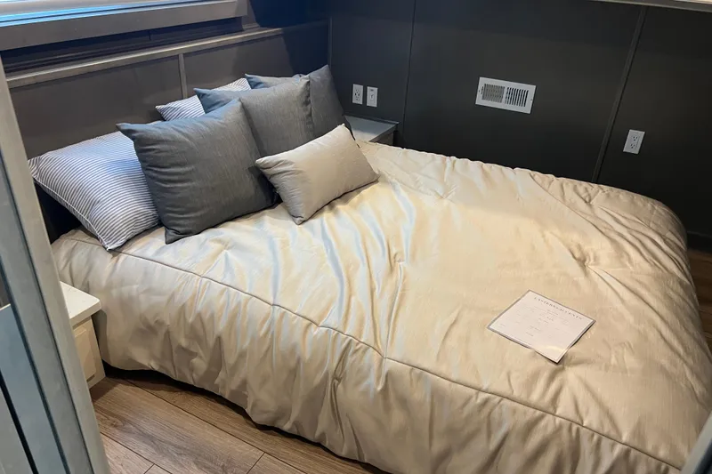 Slide: The Image of Luxurious bedroom in 2026 Sumerset Luxe II houseboat with plush bedding and modern decor. - 18