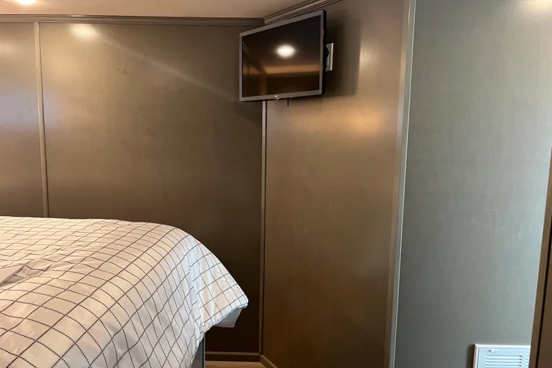 Slide: The Image of Interior of 2026 Sumerset Luxe II with wall-mounted TV and bed. - 21