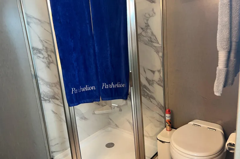 Slide: The Image of Bathroom in 2026 Sumerset Luxe II with marble shower and blue curtain. - 22