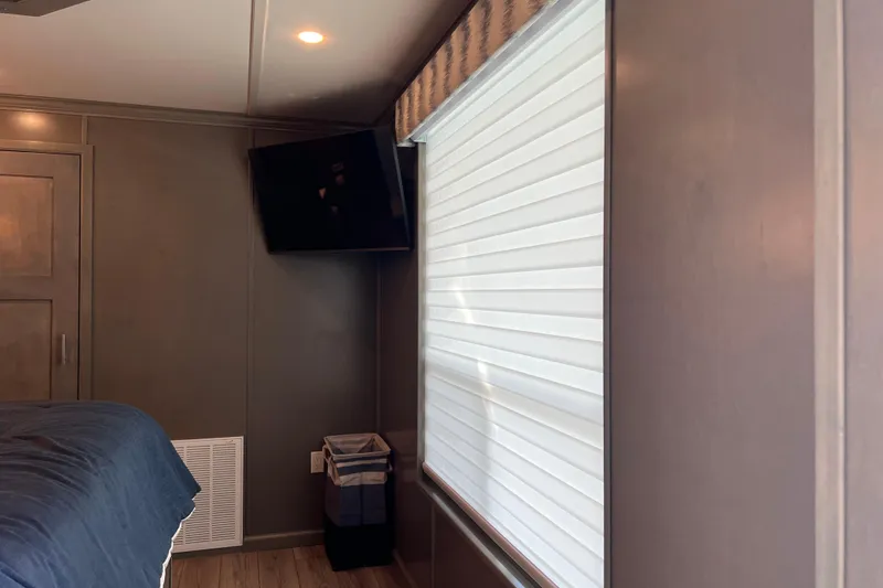 Slide: The Image of Interior of 2026 Sumerset Luxe II with modern decor, TV, and window blinds. - 26