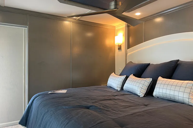 Slide: The Image of Luxurious bedroom interior in 2026 Sumerset Luxe II houseboat, featuring elegant bedding and modern lighting. - 29