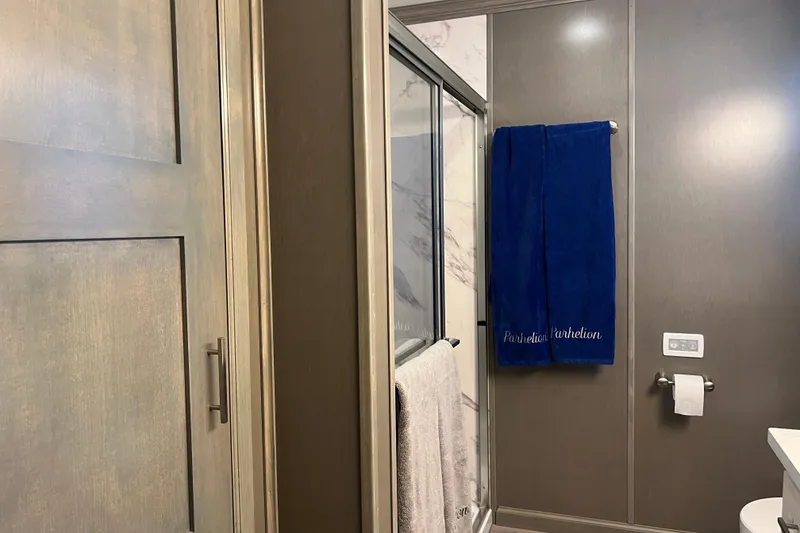 Slide: The Image of Bathroom interior of 2026 Sumerset Luxe II with modern shower and blue towel. - 32