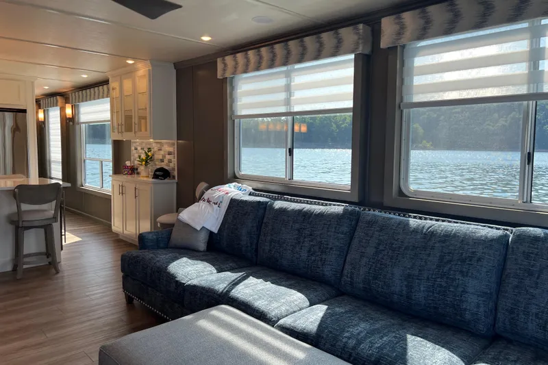Slide: The Image of Luxurious Sumerset Luxe II 2026 houseboat interior with lake view, featuring modern kitchen and cozy seating. - 4