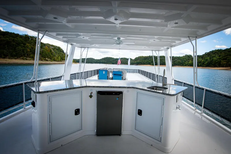 Slide: The Image of Luxurious 2026 Sumerset Luxe II houseboat with outdoor bar on serene lake. - 40