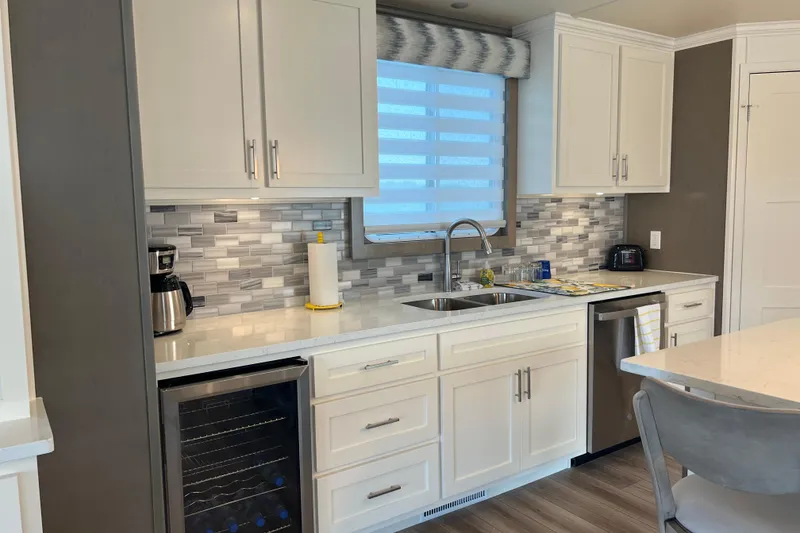 Slide: The Image of Modern kitchen in 2026 Sumerset Luxe II houseboat with sleek cabinetry and stainless steel appliances. - 7