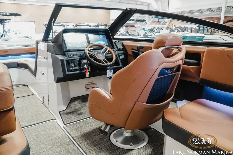 Slide: The Image of 2025 Cobalt R4 boat interior with modern dashboard and luxurious seating at Lake Norman Marina. - 12