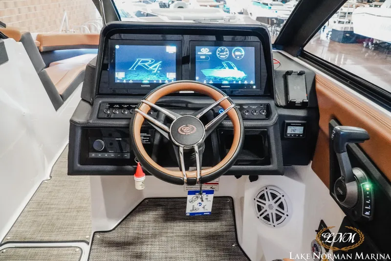 Slide: The Image of 2025 Cobalt R4 boat dashboard with dual screens and modern steering wheel. - 13