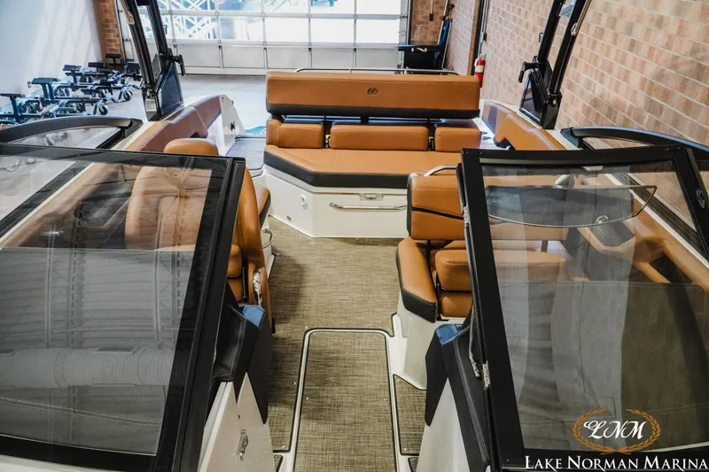 Slide: The Image of 2025 Cobalt R4 boat interior with tan leather seating at Lake Norman Marina. - 15