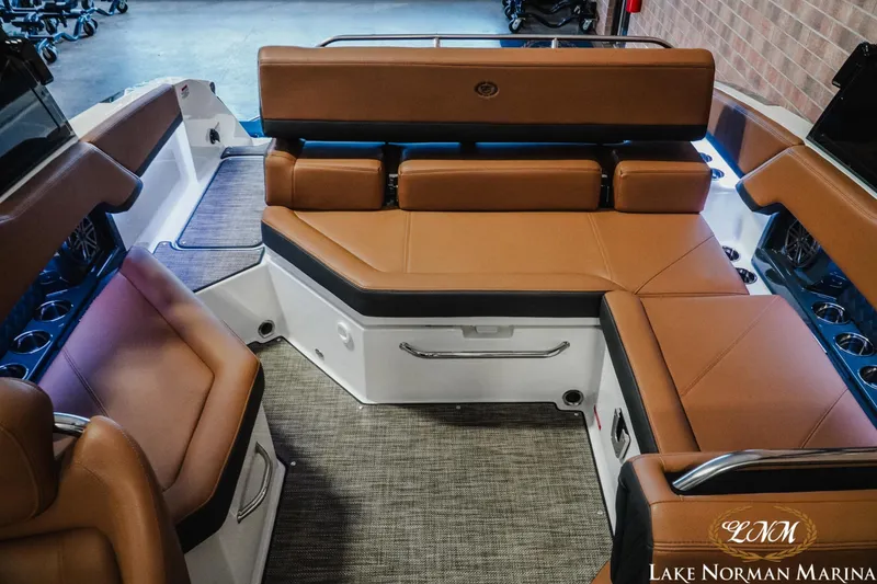 Slide: The Image of 2025 Cobalt R4 boat interior with brown leather seating at Lake Norman Marina. - 19