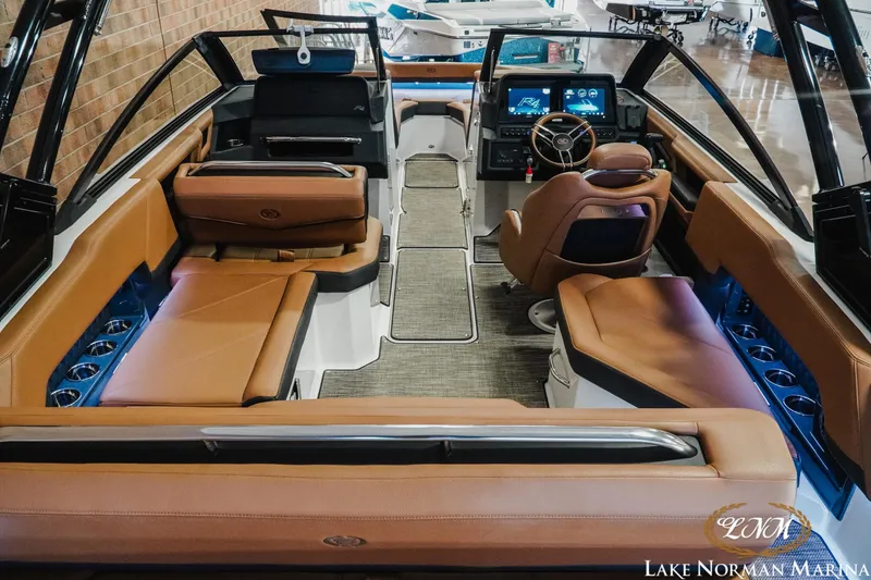 Slide: The Image of Luxurious interior of 2025 Cobalt R4 boat with brown leather seating and modern dashboard. - 8
