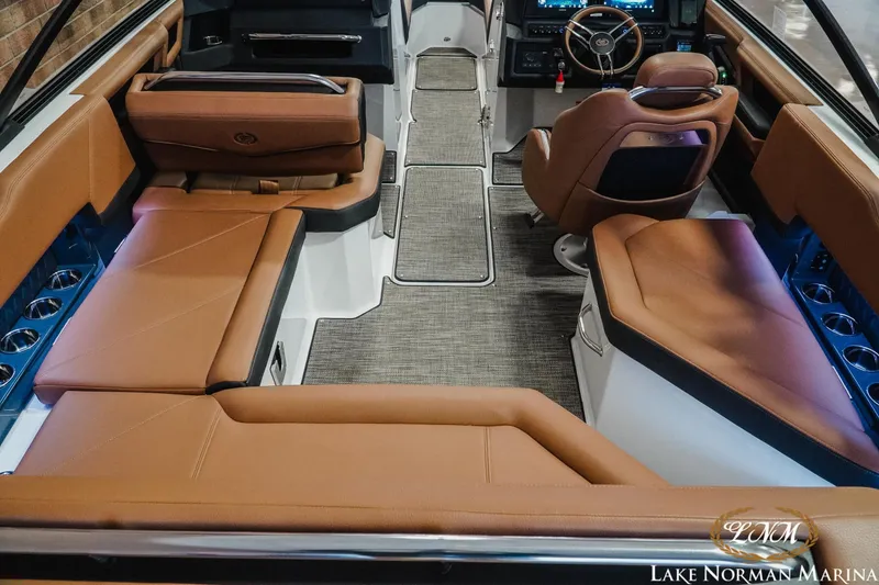 Slide: The Image of Luxurious interior of 2025 Cobalt R4 boat with brown leather seating and modern dashboard. - 9